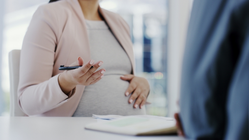 A pregnant woman discusses financial plans and private insurance options for maternity leave